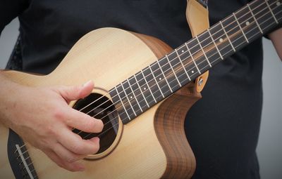 Cropped image of man playing guitar