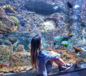 Woman swimming in sea at aquarium