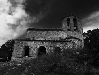 Low angle view of church against cloudy sky