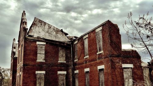 Low angle view of abandoned building against sky