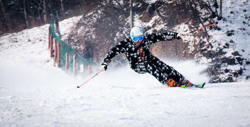 Panoramic view of person skiing in snow