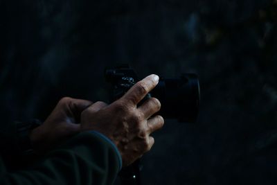 Cropped hands of man photographing