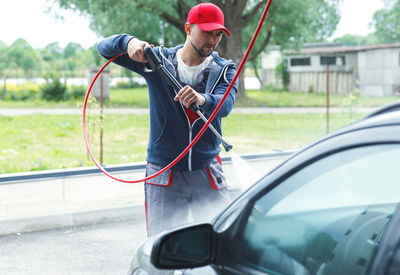 Low section of man holding car