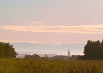 Scenic view of field against sky during sunset