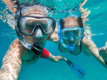 Portrait of people swimming undersea