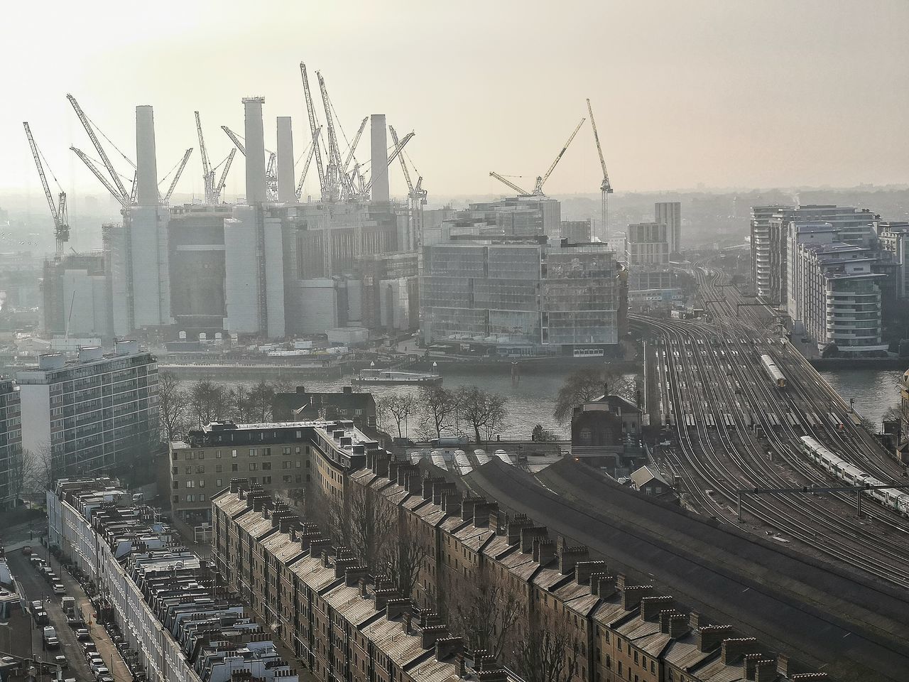 HIGH ANGLE VIEW OF CONSTRUCTION SITE AGAINST BUILDINGS