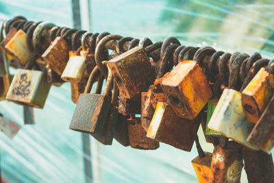 Close-up of padlocks on metal railing