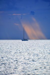 Sailboat sailing in sea against sky