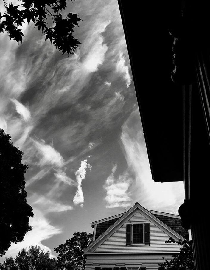 LOW ANGLE VIEW OF HOUSES AGAINST CLOUDY SKY