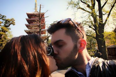 Close-up of couple kissing outside temple