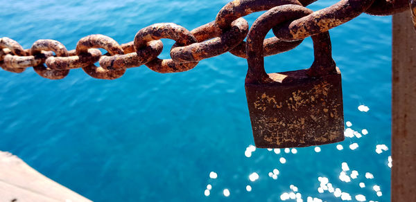 Close-up of padlocks on metal railing