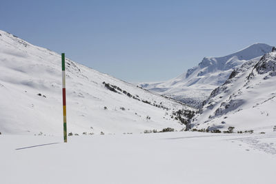 Scenic view of snow covered mountains against sky