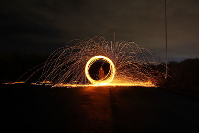 Blurred motion of person against illuminated sky