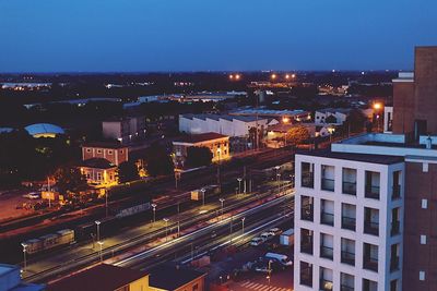 High angle view of illuminated city against sky at night