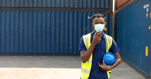 Man talking on walkie-talkie at warehouse