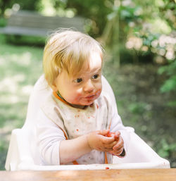 Cute boy eating fruits in garden