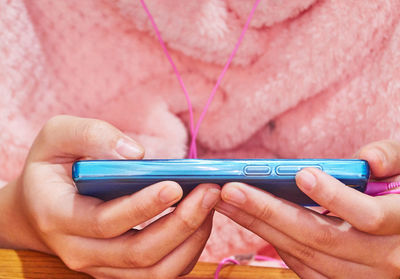 Midsection of man using mobile phone