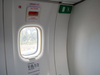 Close-up of emergency exit in airplane 