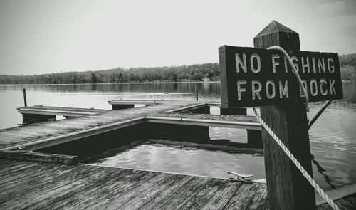 Sign on pier over lake