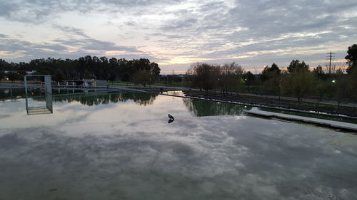 Scenic view of lake against cloudy sky