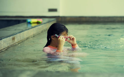 Portrait of woman swimming in pool