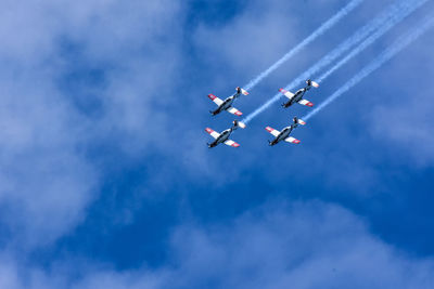 Low angle view of airshow against sky