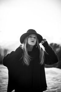 Portrait of woman standing against sky during winter