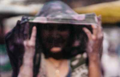 Portrait of man photographing through camera