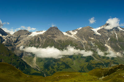 Scenic view of mountains against blue sky