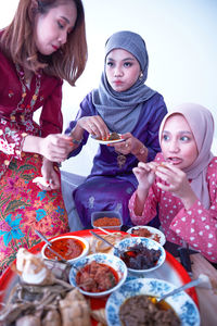 Friends and family enjoying festival meal during the eid celebration