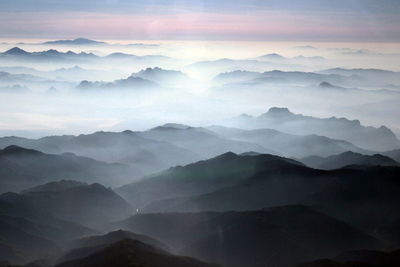 Scenic view of mountains against cloudy sky