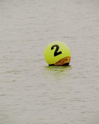 High angle view of yellow ball floating on water