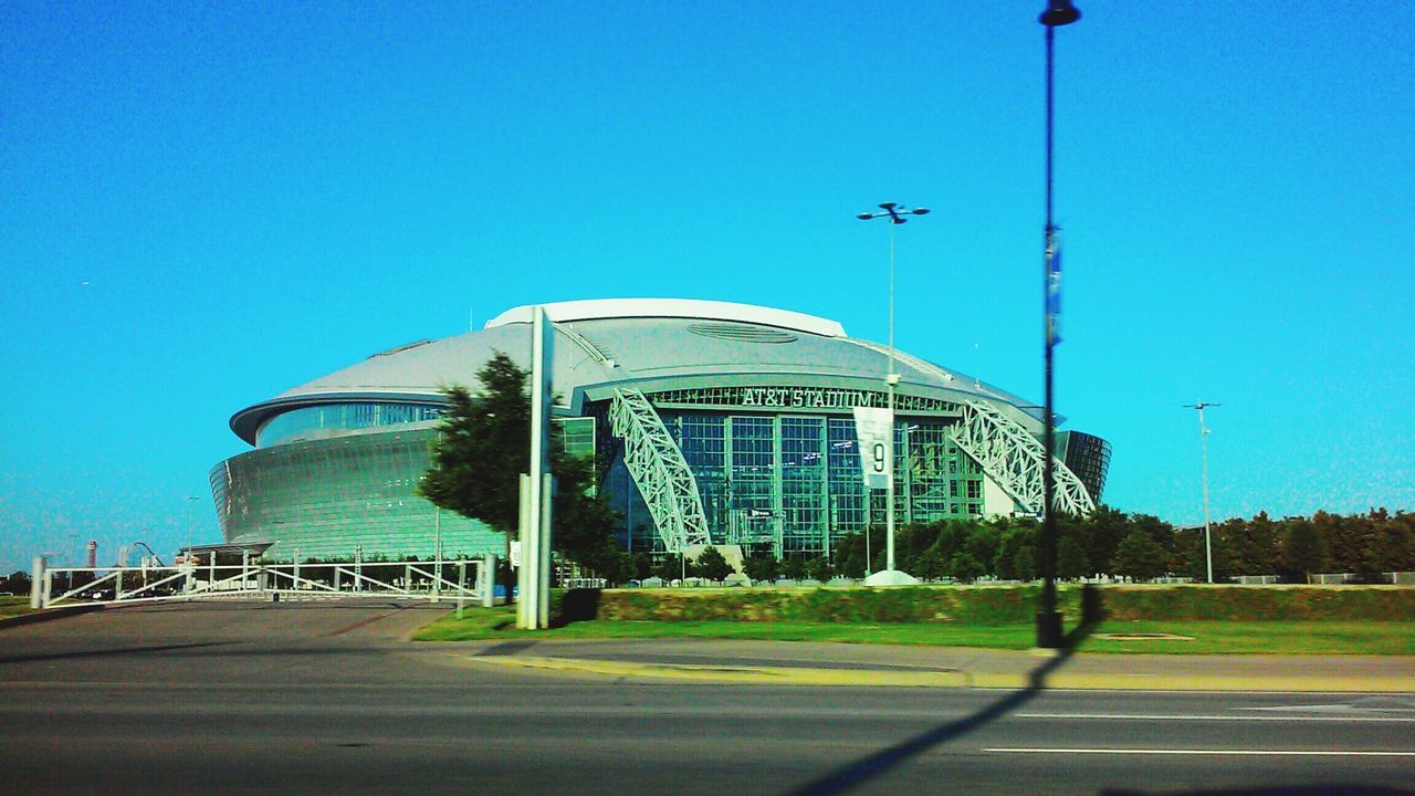 building exterior, clear sky, architecture, built structure, blue, copy space, city, street light, building, modern, street, office building, day, road, outdoors, sunlight, transportation, low angle view, skyscraper, no people