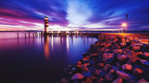 Scenic view of lake against sky at sunset