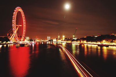 Illuminated ferris wheel at night