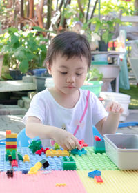 3 year asian little girl playing creative building block toy. kid activity learning and development.