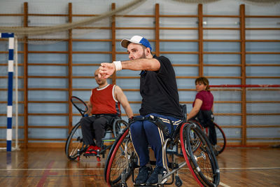 Rear view of young woman with bicycle in gym