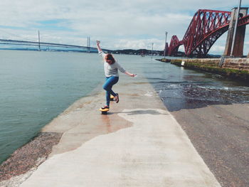 Full length of man on bridge over river against sky