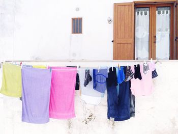 Multi colored laundry hanging outside house