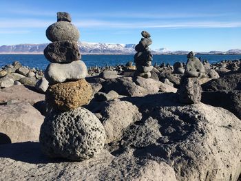 Stack of rocks on beach against sky