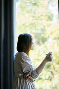 Asian woman drink coffee and relax during work at home