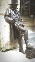 Man standing by statue