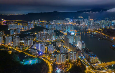 High angle view of illuminated city buildings at night