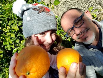 Portrait of man and woman with fruits