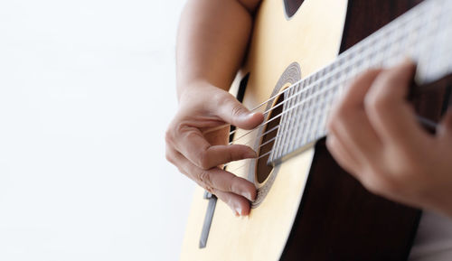 Midsection of person playing guitar