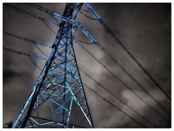 Low angle view of electricity pylon against sky