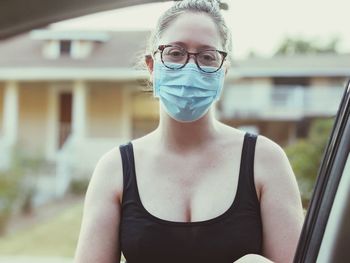 Portrait of young woman standing outdoors