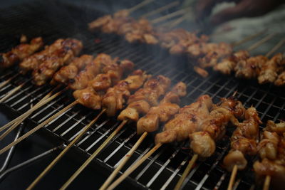 High angle view of meat on barbecue grill..satay