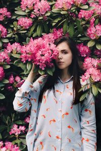 Young woman with pink flowers