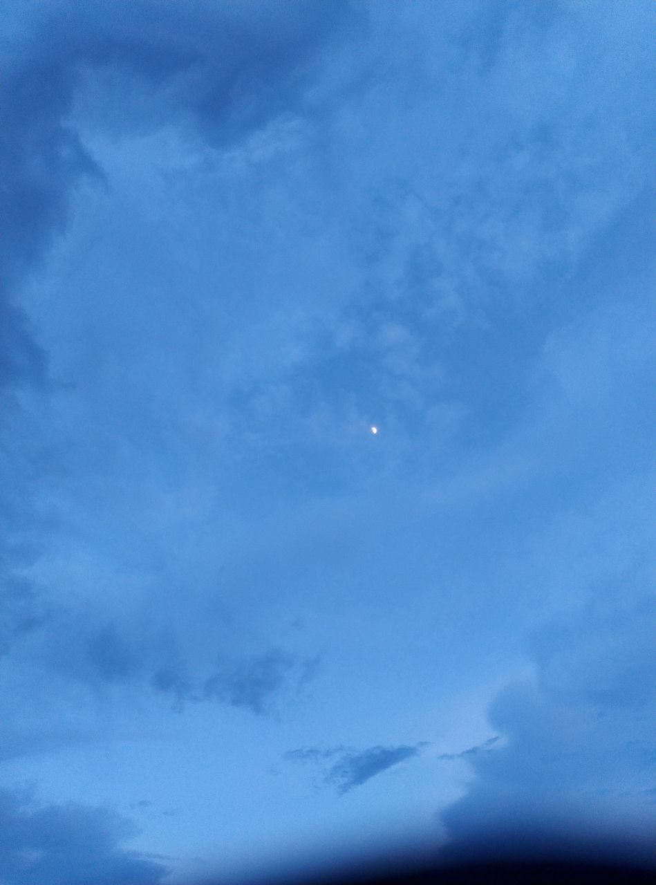 LOW ANGLE VIEW OF MOON IN BLUE SKY